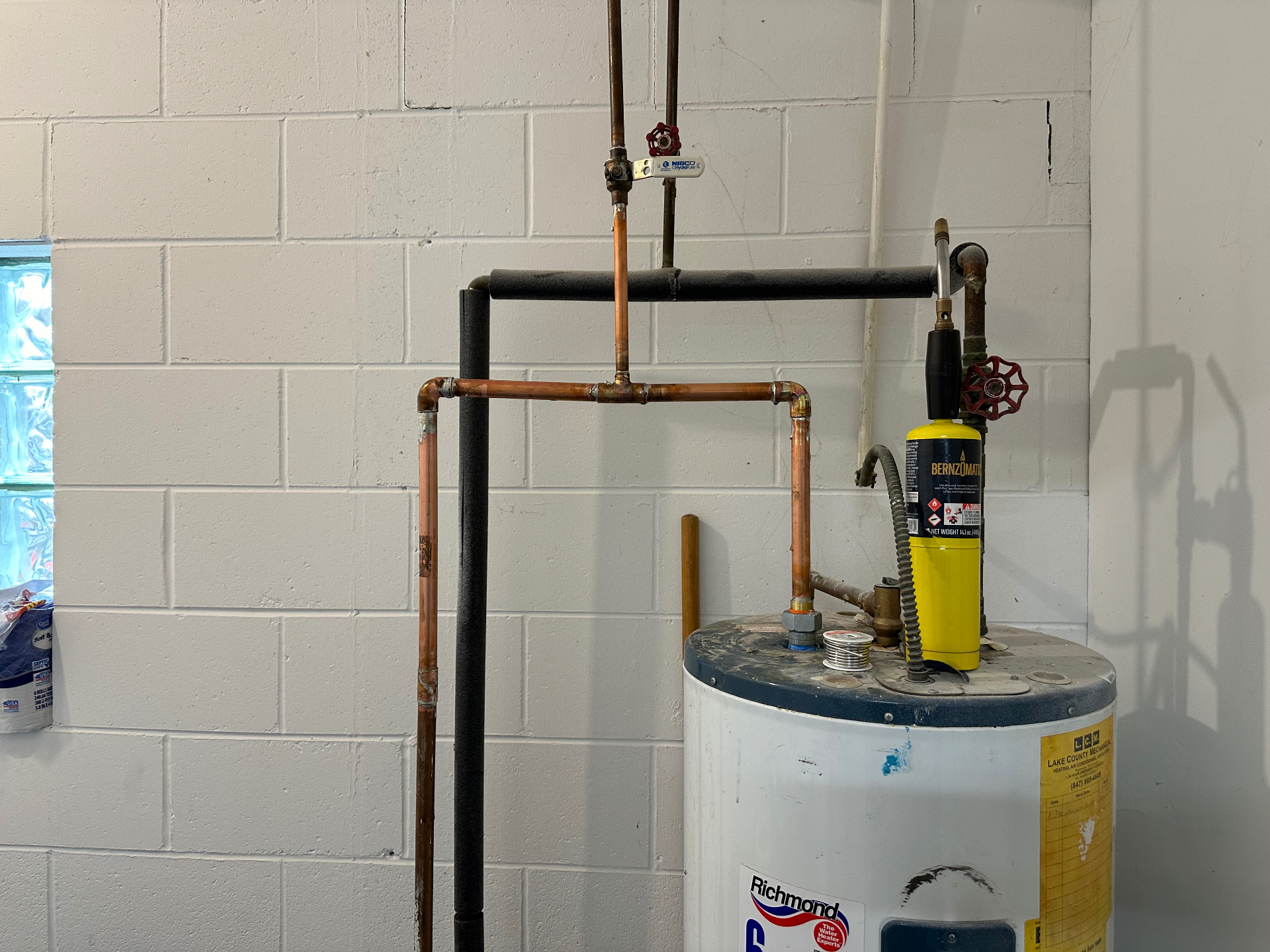 Copper repipe and water heater gas line rebuilt to code in a Lake County basement.